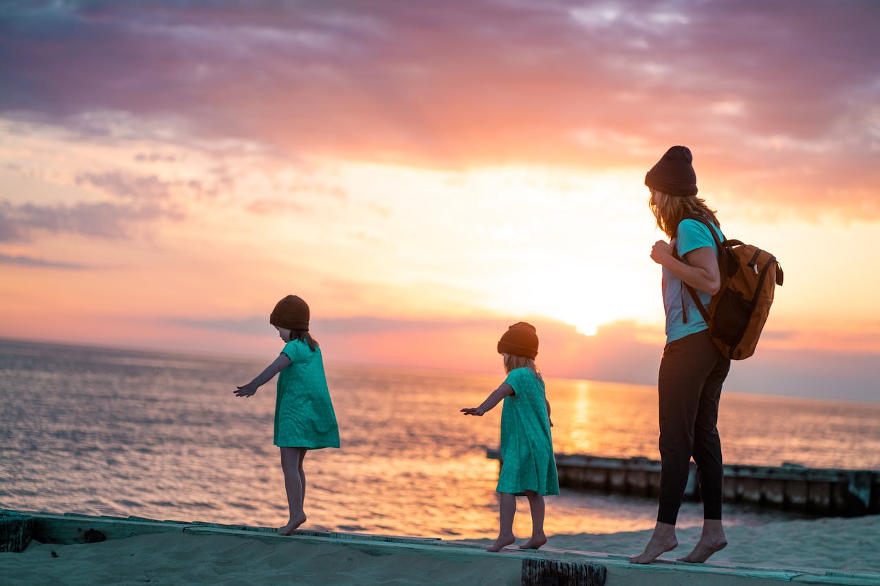 A family embraces play and togetherness on a picturesque beach during sunset in Ludington, MI.